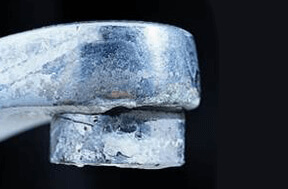 A faucet that has build up on it