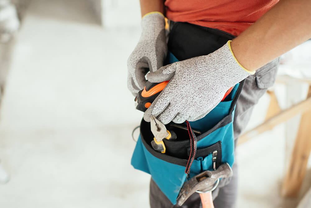 A handyman holding a tape measure