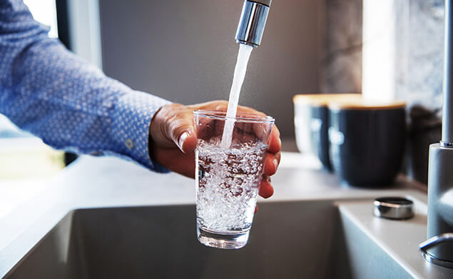 A man filling a glass with water
